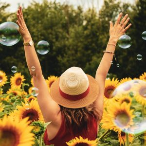 photography-of-woman-surrounded-by-sunflowers-1263986